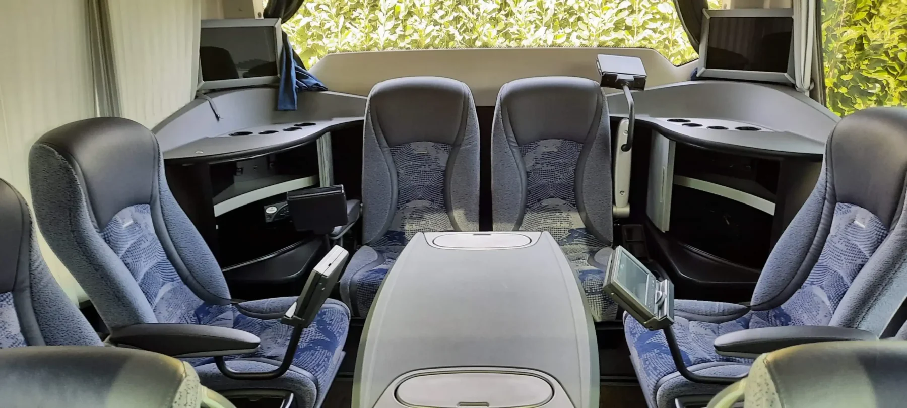 Executive coach rear lounge with a shared table