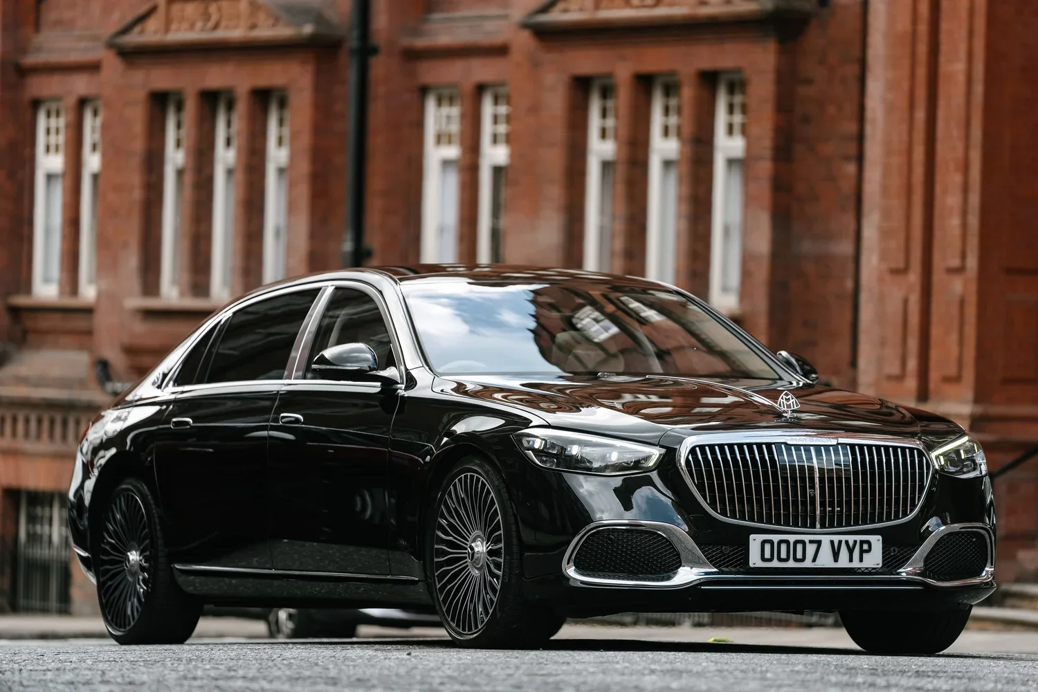 Black Mercedes-Maybach outside a red-brick London building