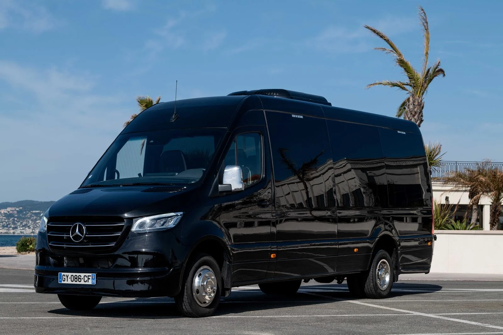 Black Mercedes Sprinter luxury minibus, exterior front three-quarter view